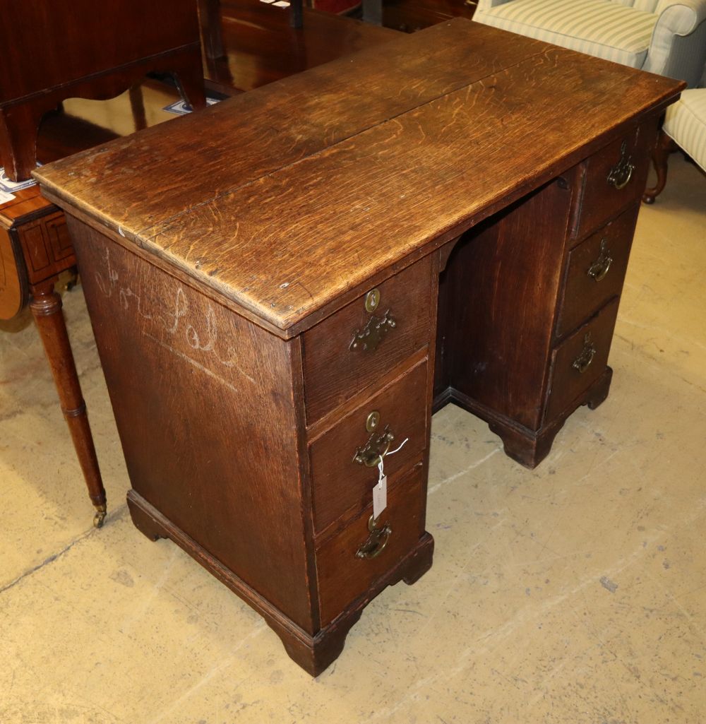 A Georgian style oak kneehole desk, W.102cm